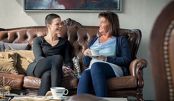 Maria Sibylla Kalverkämper und Bewerberin Ruth beim gemeinsamen Kaffee trinken auf dem Sofa
