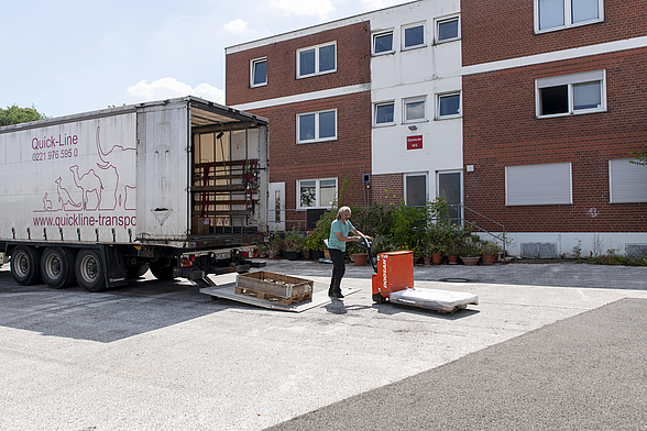 Auf dem Hof des Logistik-Unternehmens Quickline sieht man einen Mitarbeiter beim Entladen eines LKW.