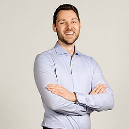 Junger Mann lächelt in Kamera